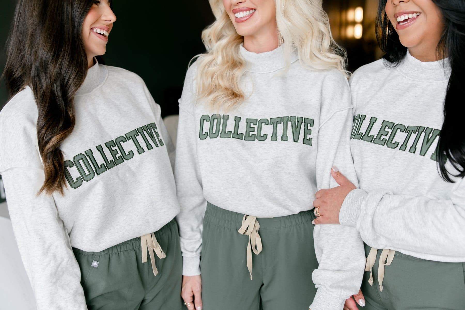 Members of our team laughing together in Collective sweatshirts